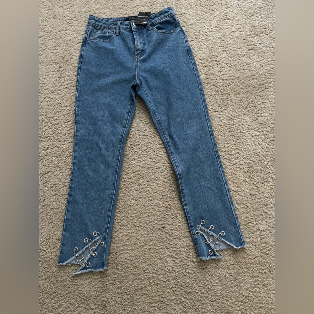 Denim blue jeans with distressed chain